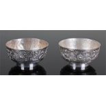 Pair of Chinese silver bowls, each bowl with two trailing dragons and dot punched ground, engraved