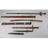 Four edged weapons, to include a Sudanese sword with sun and moon blade, a bayonet, a Malaysian