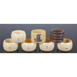 Set of Edwardian ivory napkin rings together with a turned wood example and an ivory example with