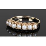 9 carat gold pearl set ring, with a row of seven pearls, ring size O