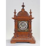 Late Victorian walnut mantel clock, the pagoda top above turned columns and reeded stepped base, the