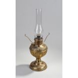 The Miller Lamp oil lamp, made in the USA, with a glass chimney above a foliate and C scroll vase