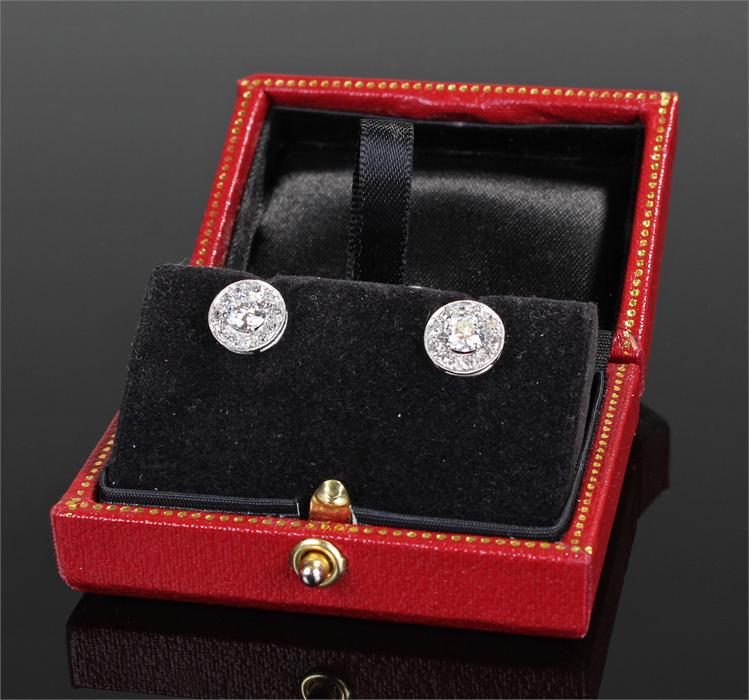 Pair of diamond ear studs, the central diamonds surround by a boarder of diamonds, approximate total - Image 2 of 2