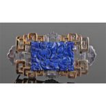 Art Deco white and yellow metal lapis lazuli brooch. The central carved lapis lazuli panel with