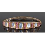 9 carat gold moonstone bracelet with a wide moonstone and garnet set bracelet with rectangular