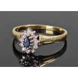 18 carat gold sapphire set ring, the central sapphire surrounded by diamonds, ring size R