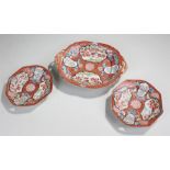 Three 19th Century Japanese dishes, each decorated with red grounds, birds among foliate panels,