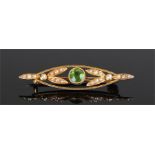 15 carat gold peridot and pearl brooch. The central peridot flanked by pearl set leafs, 43mm wide