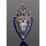 Unusual enamelled brooch. The central figural enamel centre with paste border, blue enamel edge,