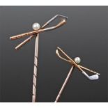 Pair of his and hers Art Deco stickpins, formed as crossed golf clubs (in white and yellow metal)