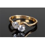 18 carat gold diamond cross over ring, the two diamonds at approximately 0.4 and 0.55 carats, ring