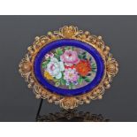 Yellow metal micromosaic brooch, the oval mosaic with blooming flowers on a blue ground, pierced