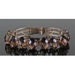 Smoky quartz bracelet with a row of ten smoky quartz set on silver gilt, 16cm long