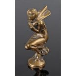 Early 20th Century car mascot in brass of a lady crouching wind swept, 13cm high