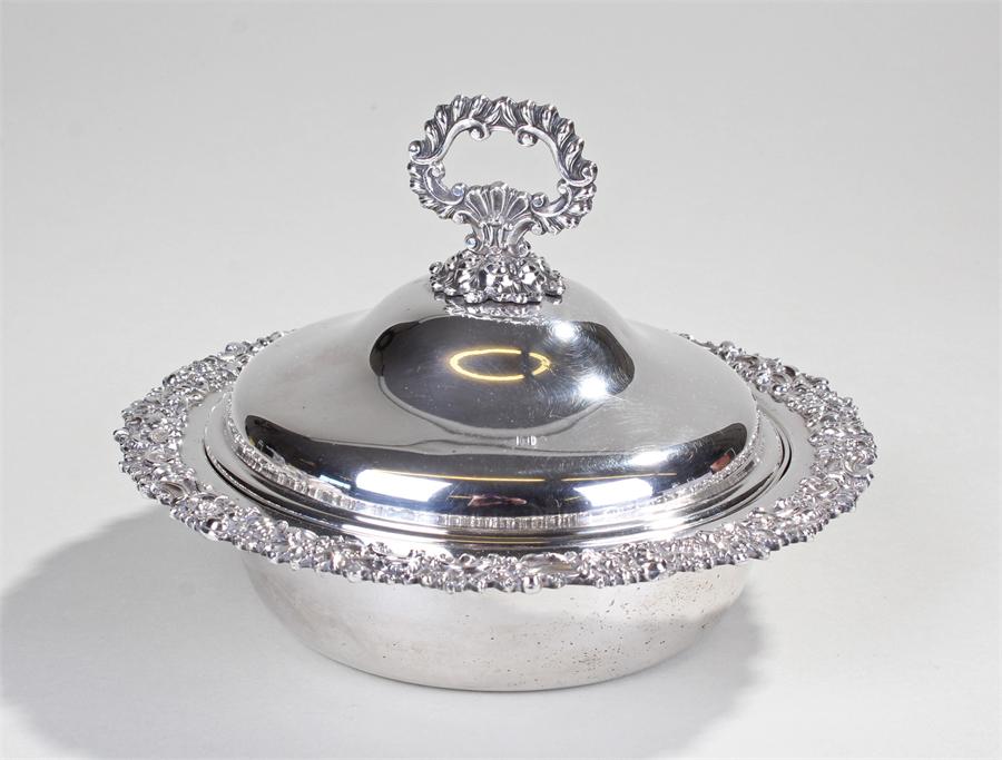 Silver and silver plated dish, the shell and foliate handle above a shaped lid with C scroll and