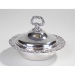 Silver and silver plated dish, the shell and foliate handle above a shaped lid with C scroll and