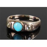 Yellow metal turquoise and diamond set ring with a central turquoise stone flanked by two