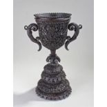 19th Century Ceylonese carved trophy cup, of large proportions, the heavily carved cup with flower