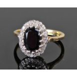 Yellow metal onyx and diamond set ring, probably 18 carat gold. The central onyx surrounded by