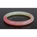 Jade bangle, from pale green to pink in colour, 8cm wide