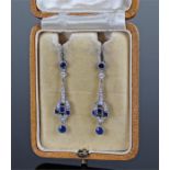 Fine pair of Art Deco diamond and sapphire earrings. The round cut sapphire below and geometric