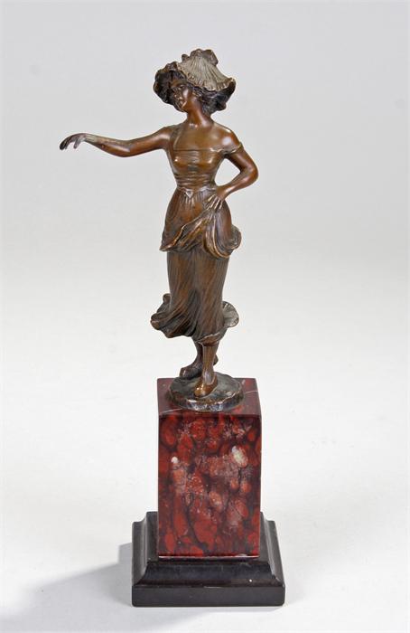 Art Nouveau bronze figure of a Dutch lady with outstretched arm, raised on a marble base, 28cm high