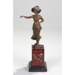 Art Nouveau bronze figure of a Dutch lady with outstretched arm, raised on a marble base, 28cm high