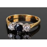 18 carat gold diamond and sapphire ring, the central sapphire flanked by two diamonds, ring size O