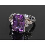 White metal amethyst and diamond ring, the central baguette cut amethyst flanked by eight