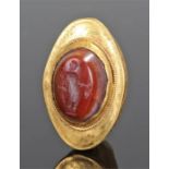 Fine Roman gold and carnelian ring, the carved carnelian in the form of a standing figure, mounted