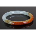 Jade bangle, with brown to celadon, 7cm wide