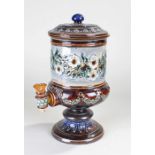 Doulton Lambeth water dispenser decorated with flowers and swags in greens, browns and blues,