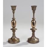 Pair of brass gold and silver inlaid candlesticks, with fluted tops above vase and disc columns,