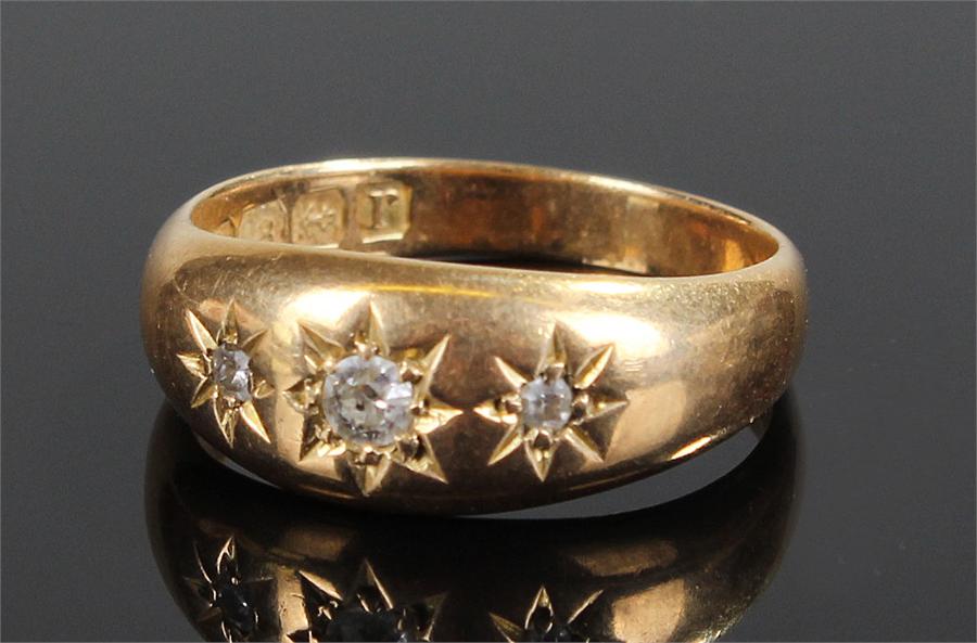 18 carat gold diamond set ring, set with three diamonds in star mounts, ring size O