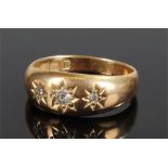 18 carat gold diamond set ring, set with three diamonds in star mounts, ring size O