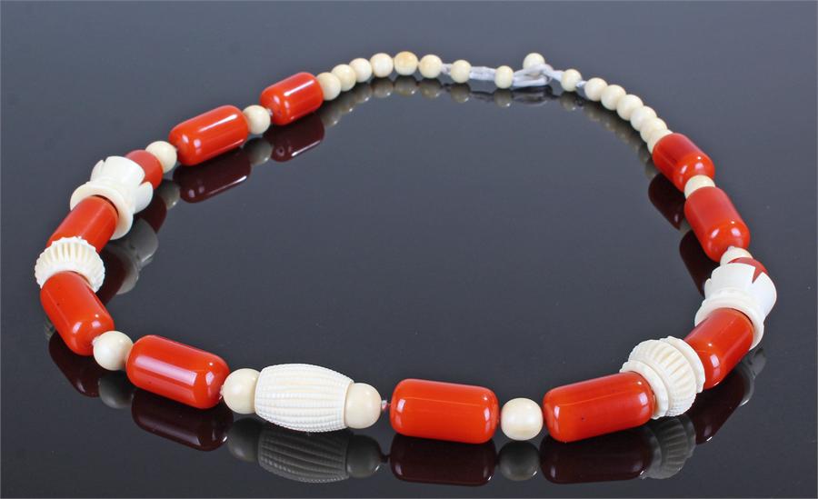 Large Art Deco bakelite and vegetable ivory necklace, with rows of red bakelite beads and