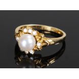 18 carat gold, pearl and diamond set ring, the central pearl surrounded by diamonds, ring size N