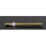 18 carat gold diamond set brooch, the stick brooch with a platinum mounted diamond, 44mm long