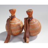 Pair of South African gourd flasks, with geometric carved design, by family repute these were