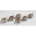 Delhi Durbar interest, a set of six white metal salts with gadrooned tapering bodies, by family