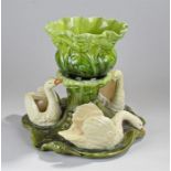 Bretby majolica table centre piece, of large proportions, the bowl above three swans on a n