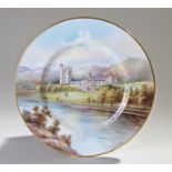 Minton plate plaque, polychrome painted depicting Balmoral Castle, signed A. Holland, the reverse