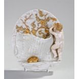 Royal Worcester porcelain wall pocket, the figure of a boy holding a hammer with a basket and a tree