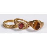 Three 9 carat gold rings, tigers eye, garnet and another, (3)