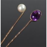 Two gold stick pins.One set an oval facetted amethyst, the other mounted with a pearl