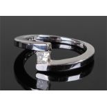 18 carat white gold and diamond ring, the central 0.3 carat diamond flanked by a angled bar shank,