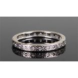 18 carat white gold and diamond set wedding band, with a row of diamonds set into the engraved band,