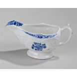 Lowestoft porcelain sauce boat, decorated in shallow relief with scrolling floral sprays and in