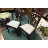 Set of four Chippendale style dining chairs, with a pierced splat above drop in seat and claw and