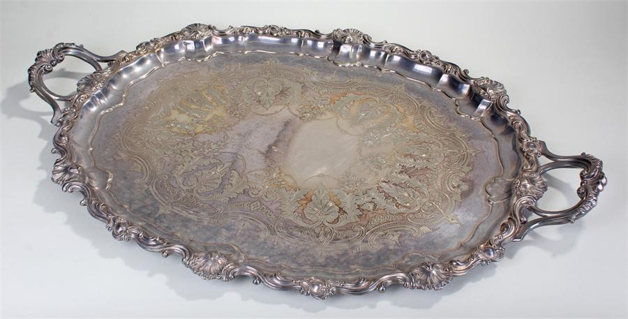 Large silver plated tray, the shell and C scroll border with further scrolls to the handles, leaf
